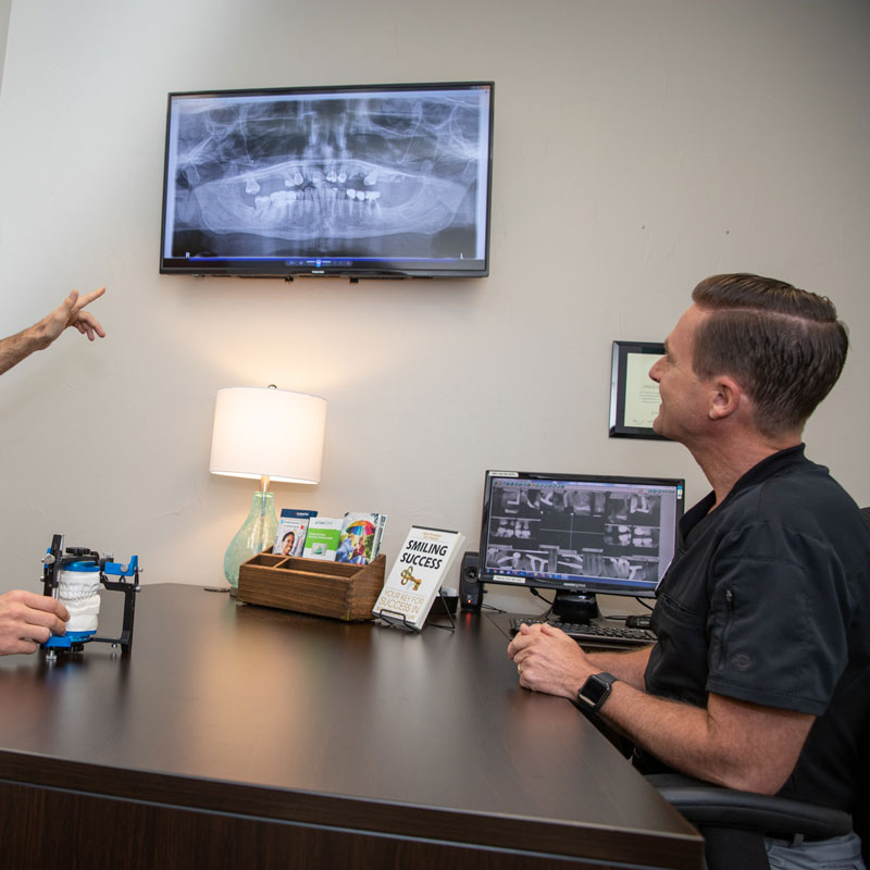 dentist looking at xray of teeth